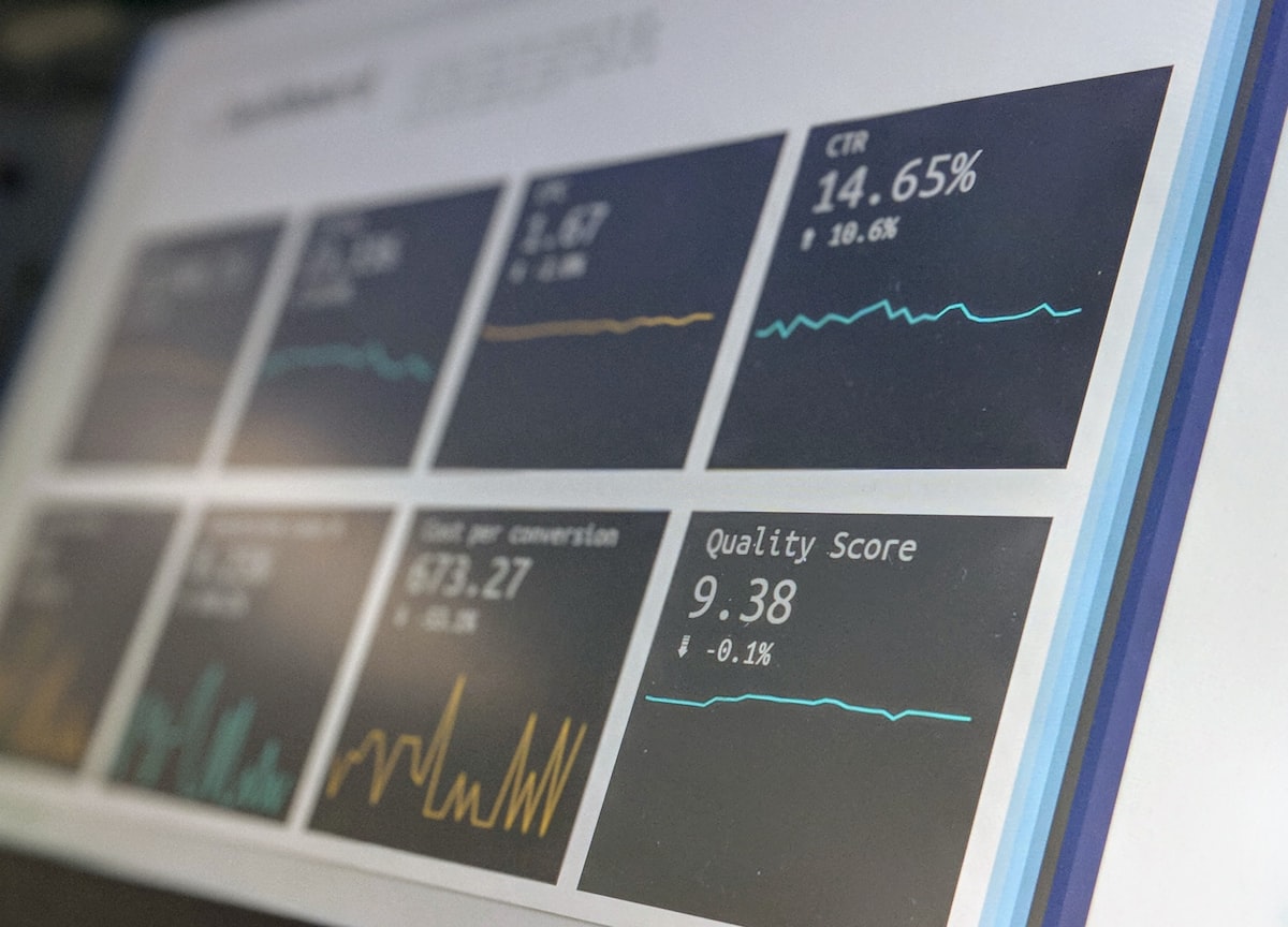 Enterprise financial analytics dashboards on monitors showing payment data and account metrics for B2B operations