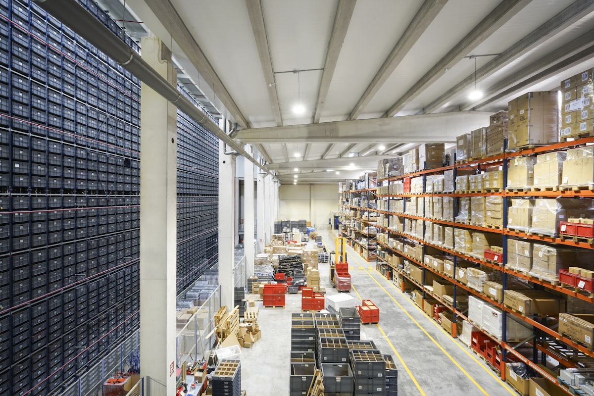 Large industrial warehouse with stacked inventory, representing B2B distribution and fulfillment automation