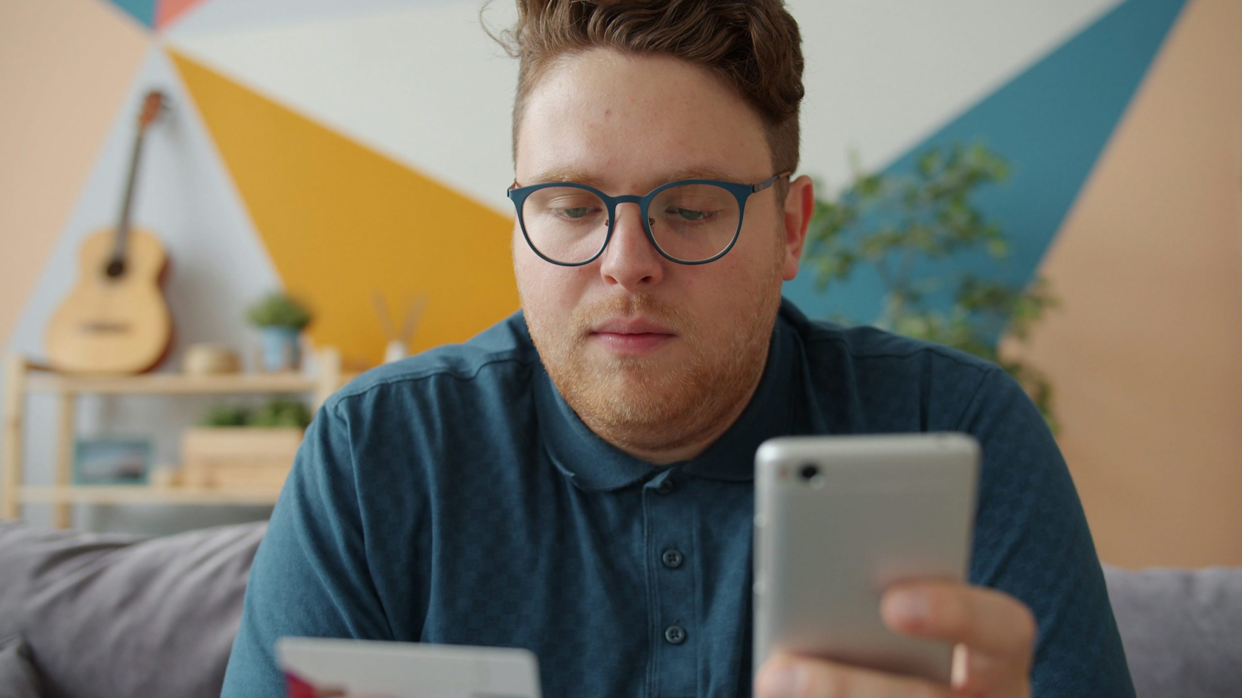 Consumer completing a mobile ecommerce purchase using a credit card and smartphone