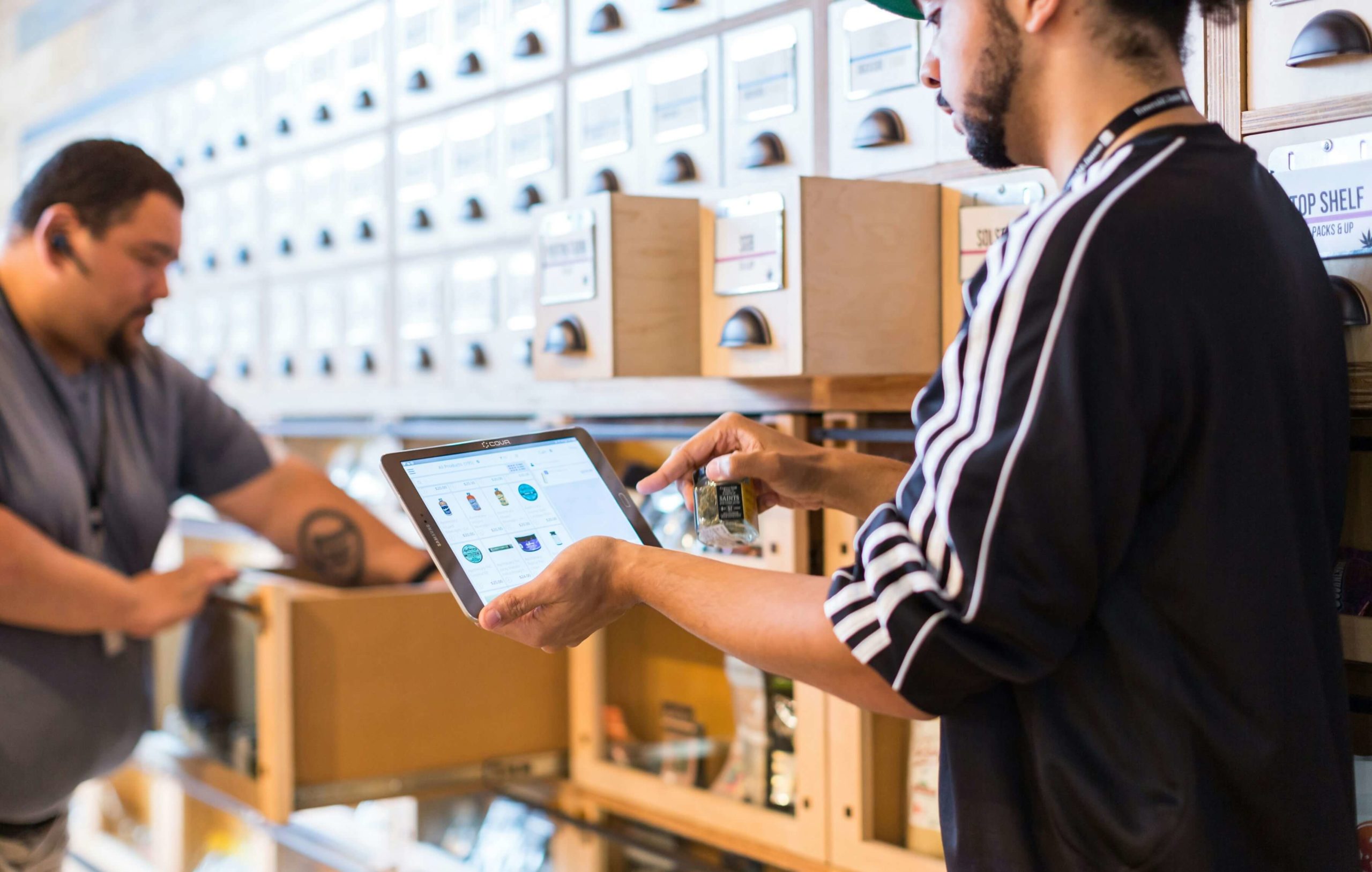 Retail worker using tablet for product scanning