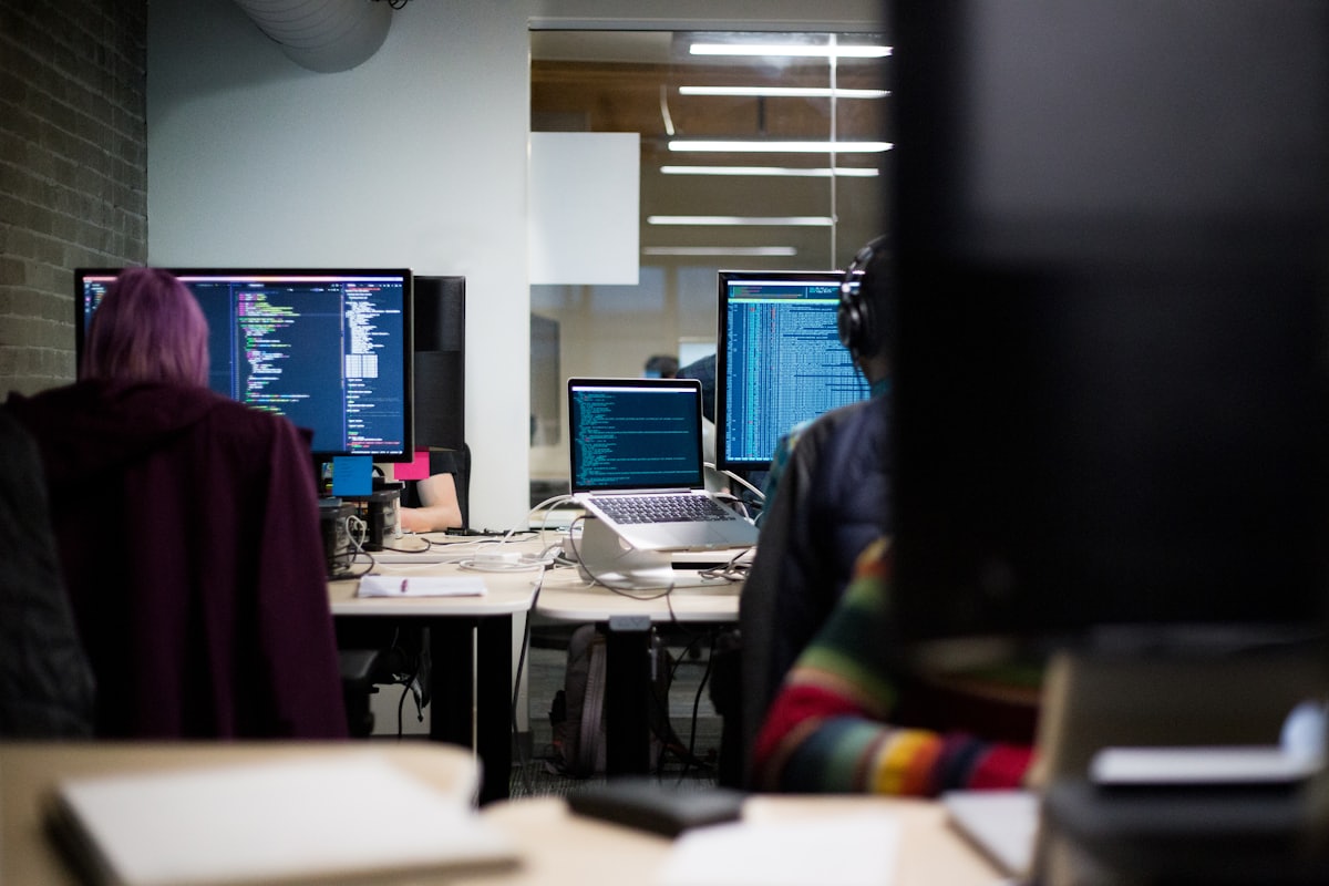 A development team working on code at a shared workspace